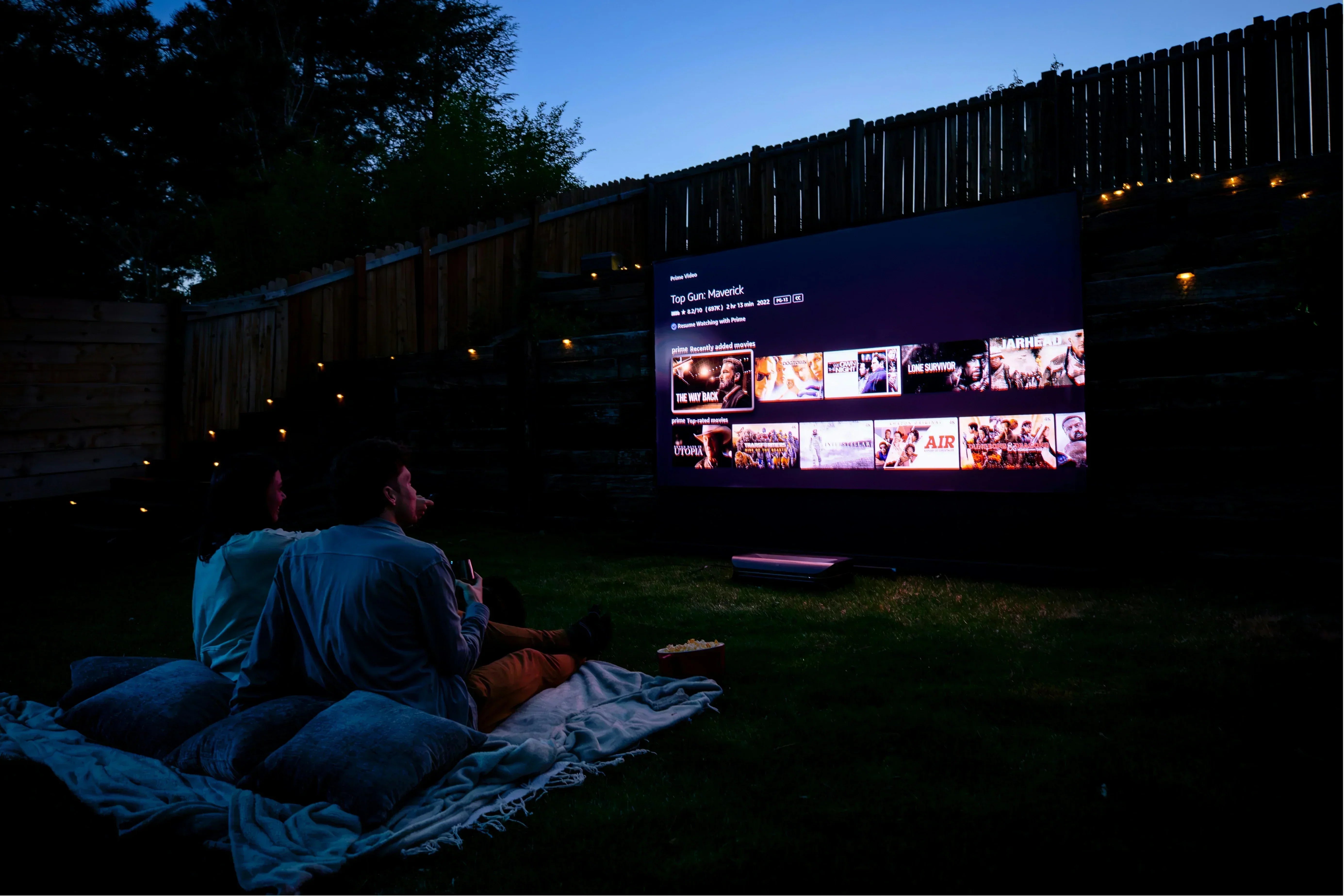 Portable outdoor projector creating a home theater atmosphere under the night sky